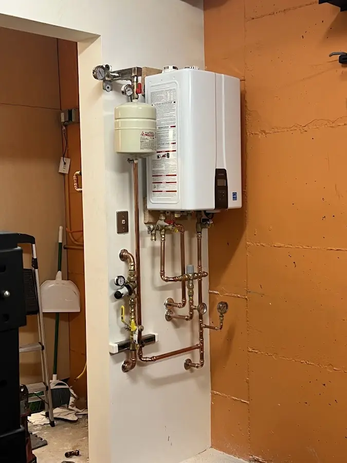 Plumbing technician inspecting water heater connections in Southwest Ranches